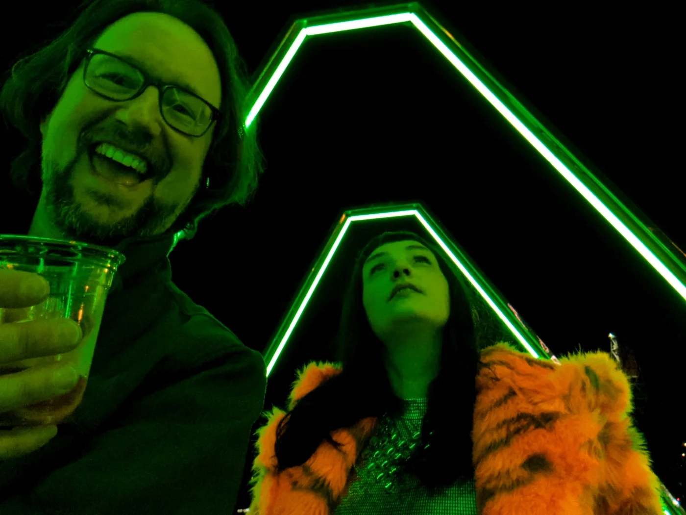 Ryan and Elisa Abts together beneath green lights